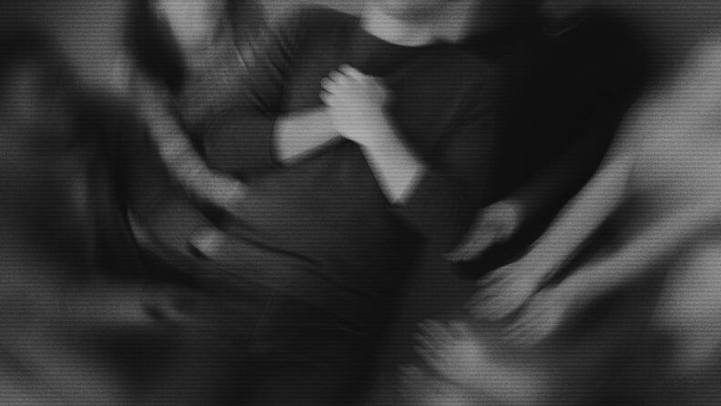 A man with clasped arms falling backward into a crowd